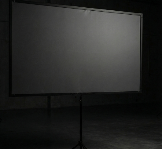 A projection screen mounted on a stand for displaying interactive combat scenarios and laser simulator targets